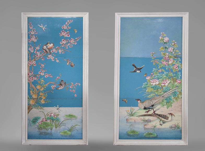 A pair of ceramic panels with birds in a lacustrine scenery signed 