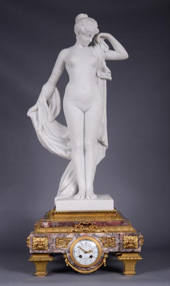 Peach blossom marble and gilt bronze clock surmounted by a statuary white marble   sculpture representing Phryne in front of his judges signed 