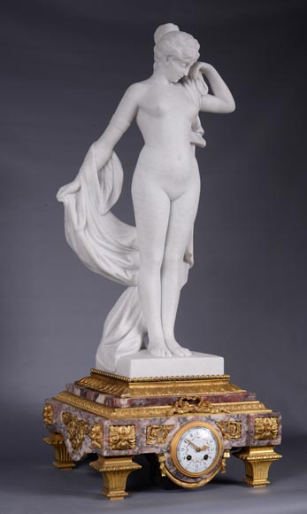 Peach blossom marble and gilt bronze clock surmounted by a statuary white marble   sculpture representing Phryne in front of his judges signed 