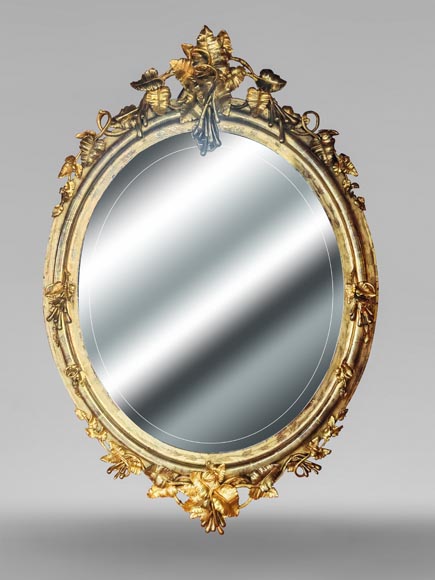 Oval gilt mirror in the Napoleon III style, featuring rich foliate ornamentation-0