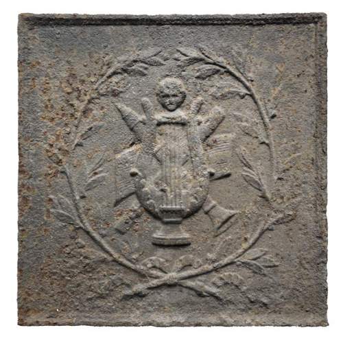 Fireback decorated with antique musical instruments surrounded by a laurel wreath