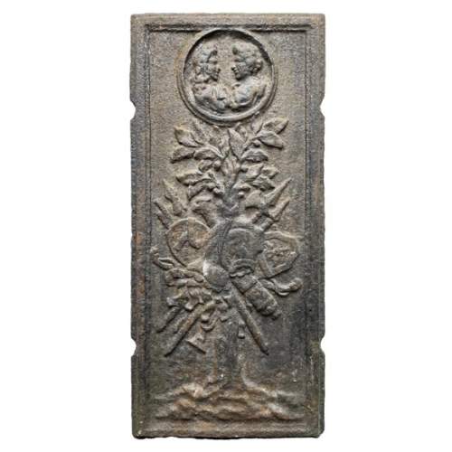 17th century fireback decorated with a warrior trophy surmounted by a medallion with a double portrait