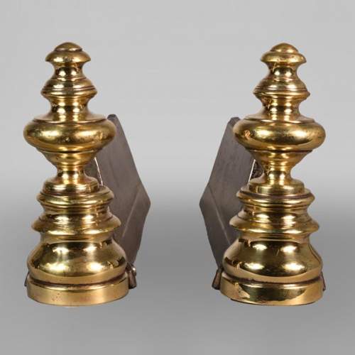 Pair of cast iron and polished bronze andirons