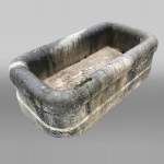 A large antique carved stone watering trough