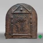 Cast iron fireback dated 1693, decorated with a radiant sun and architectural symbols