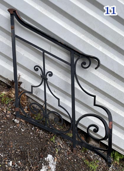 Set of wrought-iron railings featuring a design of scrolls and volute terminals, including both straight and raked sections-11