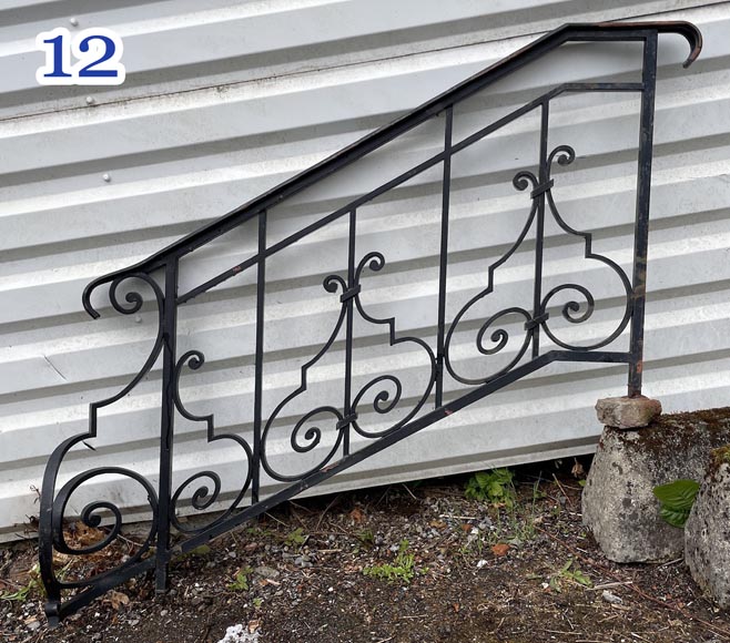 Set of wrought-iron railings featuring a design of scrolls and volute terminals, including both straight and raked sections-12
