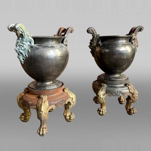 Pair of Japonesque-style cast-iron vases on bases with claw feet