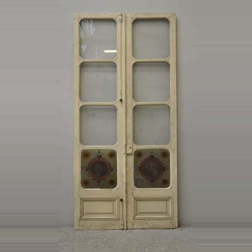 Double door with stained glass windows,  man and woman's profile in medallion