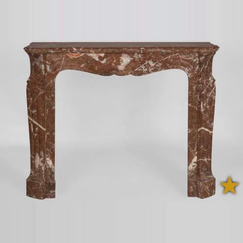 An antique Louis XV style fireplace, Pompadour model, made out of Rouge du Nord marble