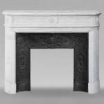 Louis XVI style Carrara marble mantel with rounded corners adorned with a sunflower flower