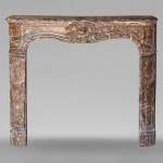 Louis XV period mantel in Rouge Royal marble adorned with a shell