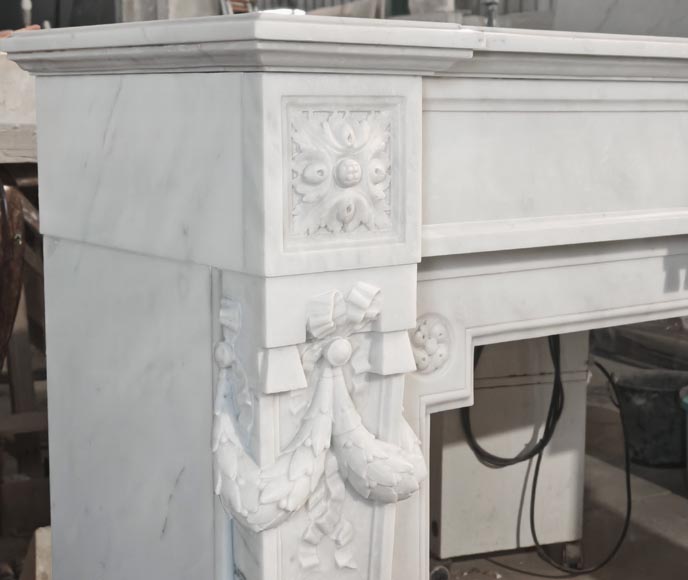 A Louis XVI style fireplace, richly decorated with garlands and vases, in Carrara marble-5