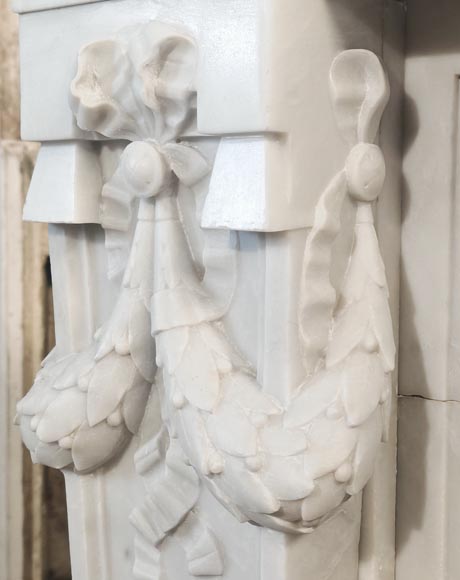 A Louis XVI style fireplace, richly decorated with garlands and vases, in Carrara marble-6