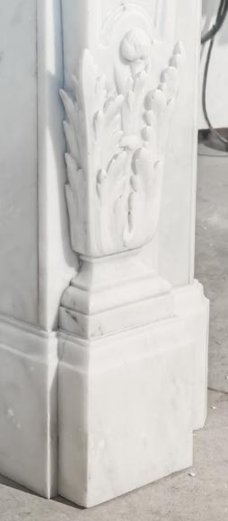 A Louis XVI style fireplace, richly decorated with garlands and vases, in Carrara marble-7