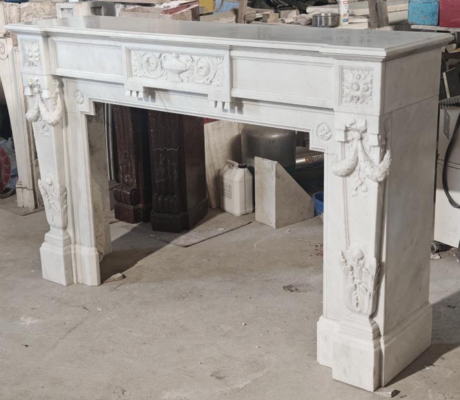 A Louis XVI style fireplace, richly decorated with garlands and vases, in Carrara marble-8