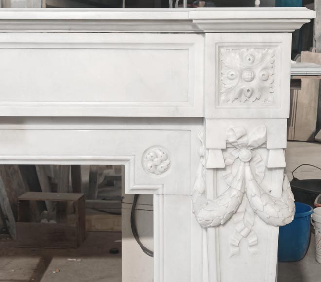 A Louis XVI style fireplace, richly decorated with garlands and vases, in Carrara marble-9