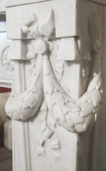 A Louis XVI style fireplace, richly decorated with garlands and vases, in Carrara marble-10