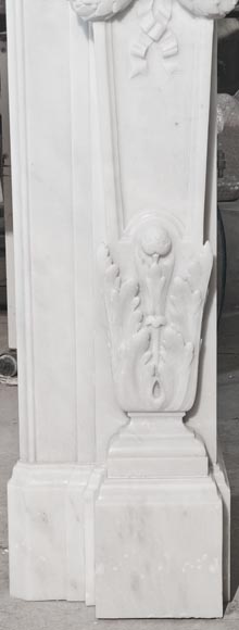 A Louis XVI style fireplace, richly decorated with garlands and vases, in Carrara marble-11
