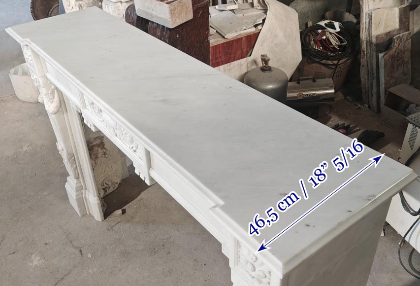 A Louis XVI style fireplace, richly decorated with garlands and vases, in Carrara marble-12