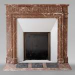 Louis XVI style mantel with acroterion in Rouge du Nord marble