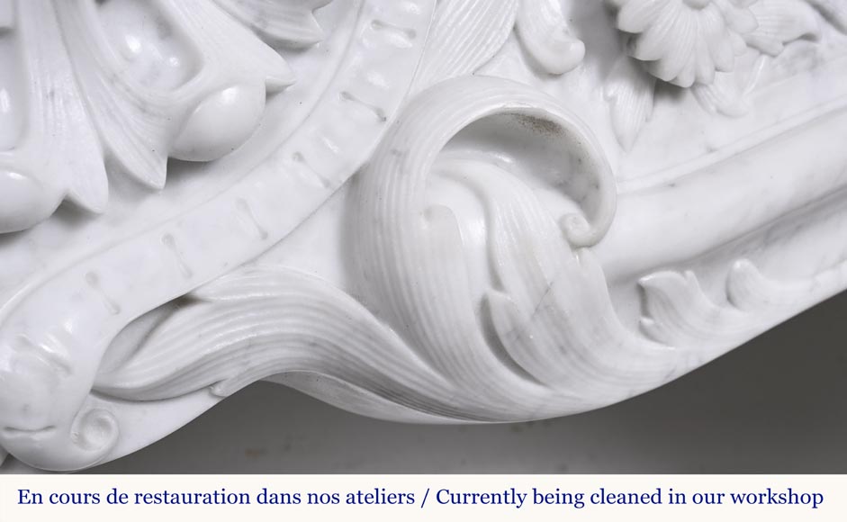 A highly sculpted Louis XV style fireplace in Carrara marble, decorated with a shell motif.-5
