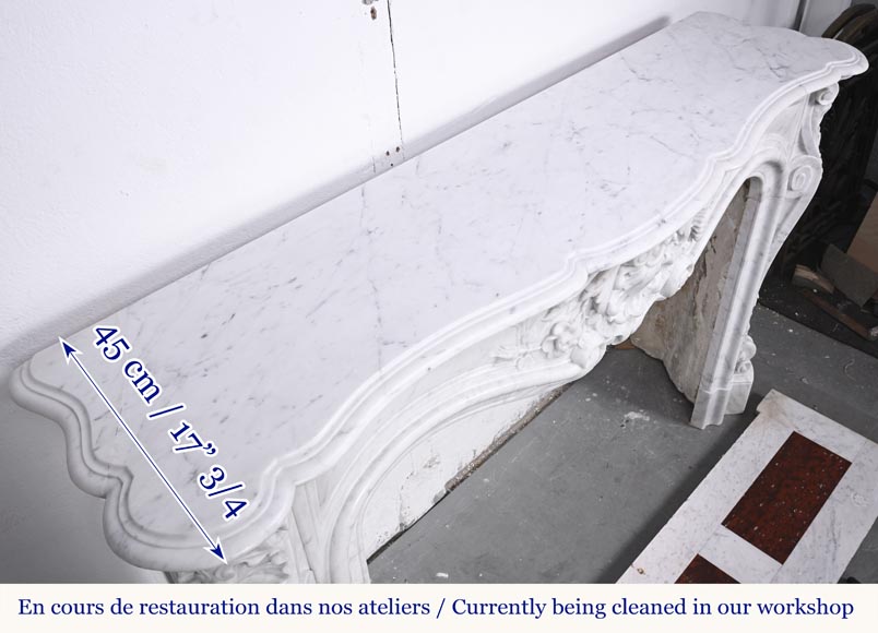 A highly sculpted Louis XV style fireplace in Carrara marble, decorated with a shell motif.-15