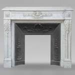 Louis XVI style Carrara marble mantel adorned with a laurel wreath