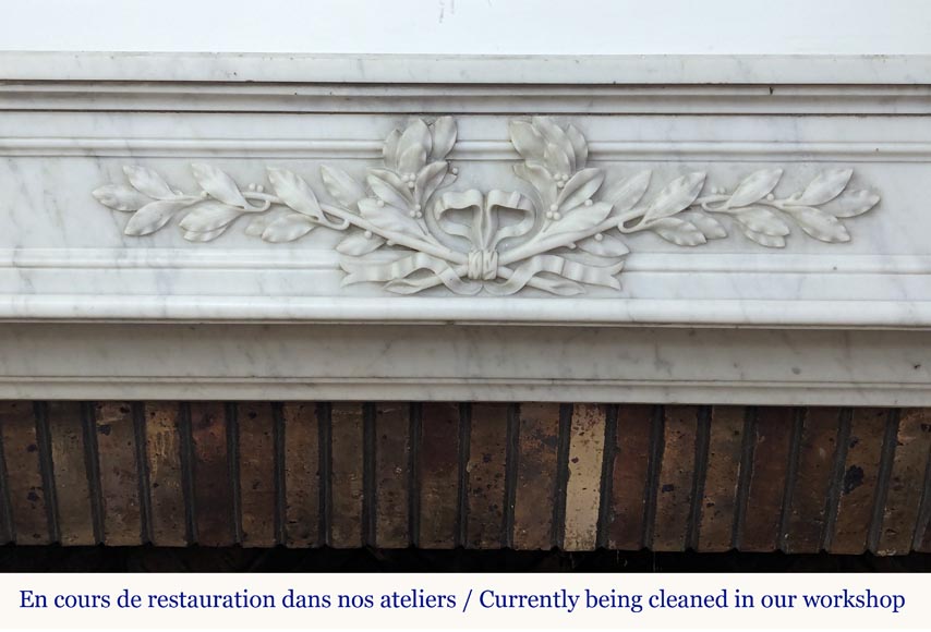 Louis XVI style Carrara marble mantel adorned with a laurel wreath-1