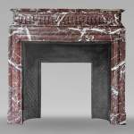 Louis XIV style mantel with acroterion in Rouge du Nord marble