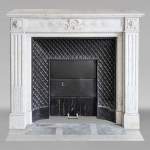 Louis XVI style mantel in Carrara marble adorned with a laurel wreath