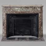 Louis XVI style mantel with rounded corners and bronze ornaments