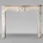 Louis XV period carved stone mantel with shell, 18th century