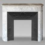 Louis XVI style mantel with rounded corners and carved sunflower in cristaline marble