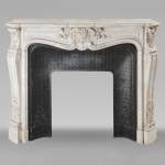 Louis XV style mantel in Carrara marble adorned with a finely carved palmette