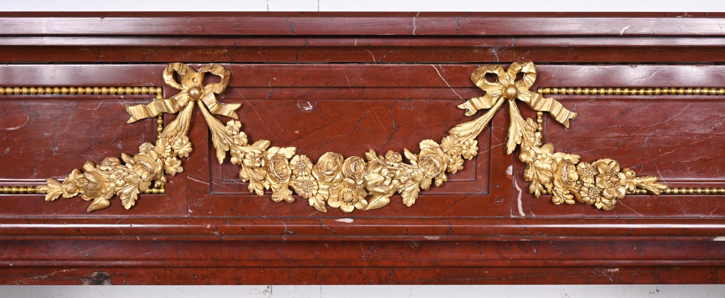 Louis XVI style fireplace in Antique Red marble, with bronze mounts, decorated with a garland-1