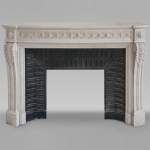 Louis XVI style curved Carrara marble mantel decorated with a frieze of macaroons