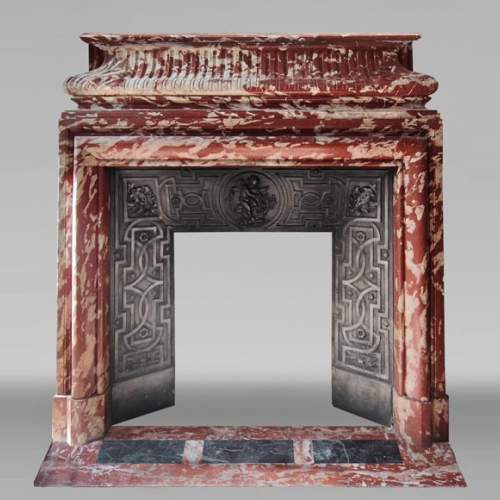 Louis XIV style fireplace with acroteria, in Red Languedoc marble