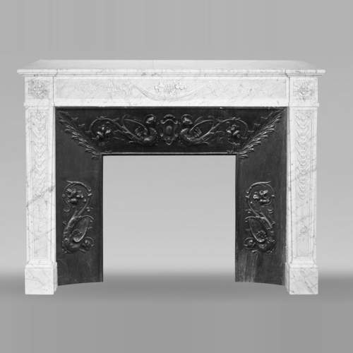 Louis XVI period fireplace with carved fruit decoration, in veined Carrara marble