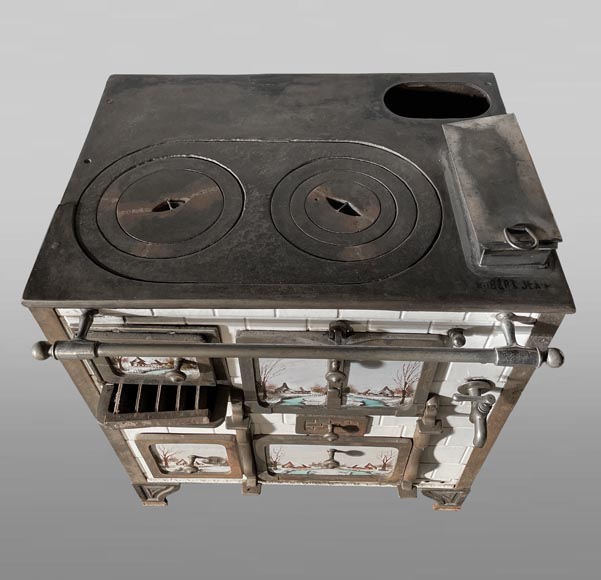 Cast-iron stove with faience imitation and snowy landscape decoration Cast-iron stove with faience imitation and snowy landscape decoration-1