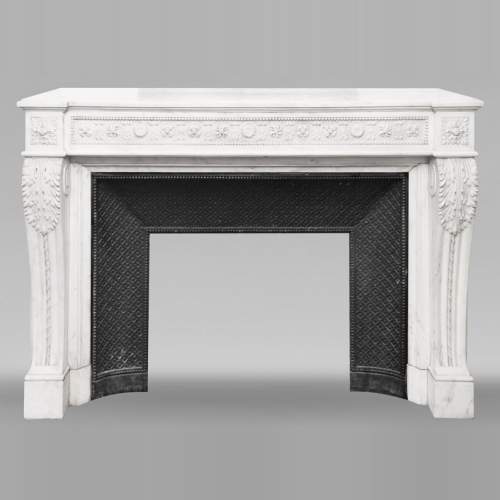 Louis XVI style fireplace decorated with macarons and pearls, in Carrara marble