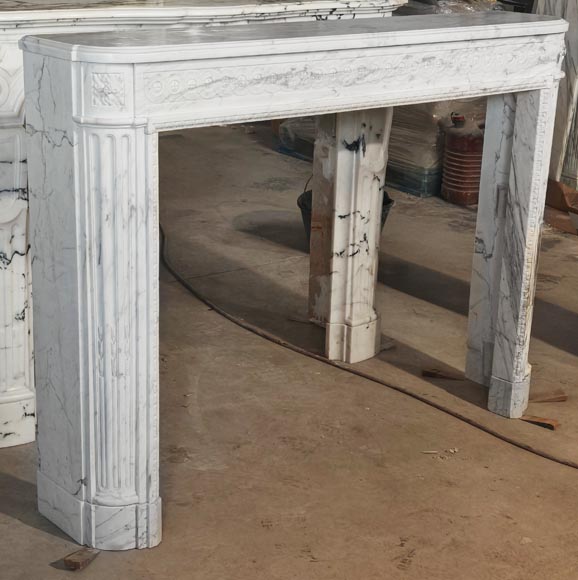 A Louis XVI period fireplace in veined Carrara marble, decorated with a Greek-style frieze.-2