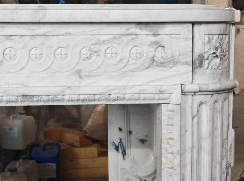 A Louis XVI period fireplace in veined Carrara marble, decorated with a Greek-style frieze.-7