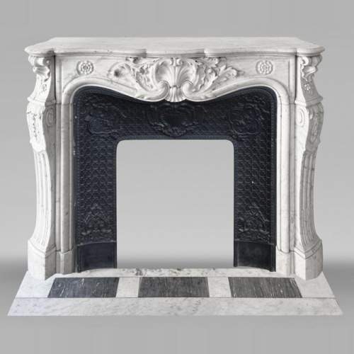 Louis XV style fireplace adorned with a large shell