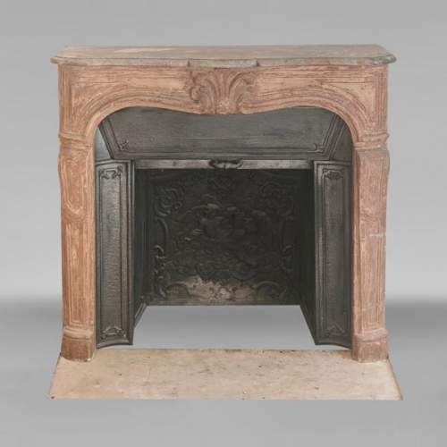 Louis XV-style stone fireplace, adorned with a palmette