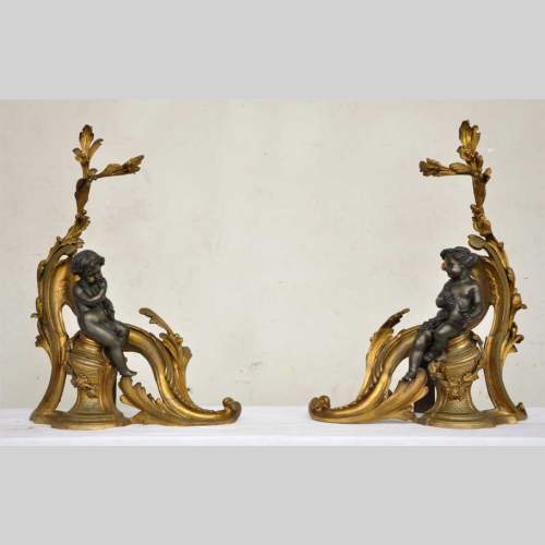 Antique firedogs with wine allegory